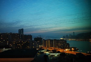 A sliver of moon prepares to call it a night, as dawn begins lighting the sky.